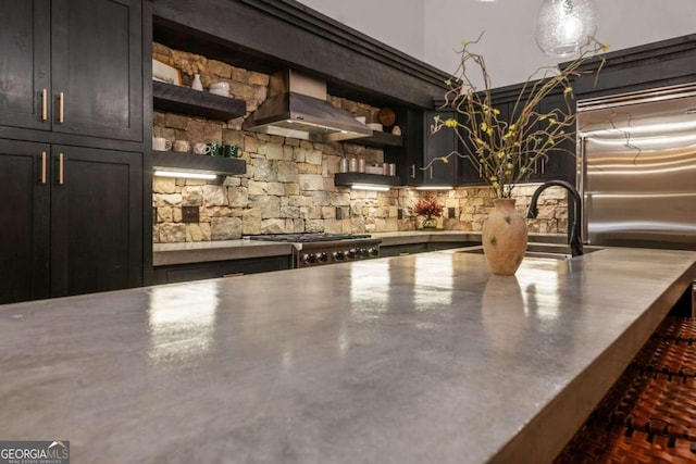 bar featuring concrete floors, wall chimney exhaust hood, stainless steel counters, built in refrigerator, and stove