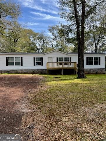 back of house featuring a deck and a yard