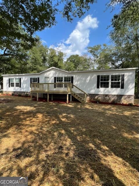 back of house featuring a deck