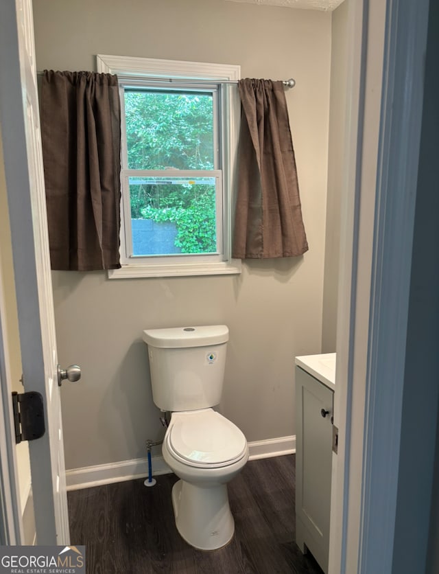 bathroom with vanity, hardwood / wood-style floors, and toilet