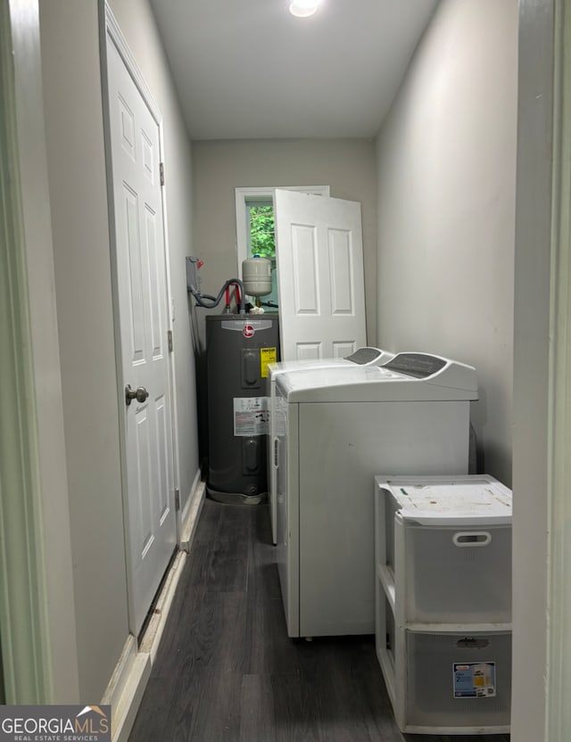 laundry area with water heater, dark wood-type flooring, and washer and dryer