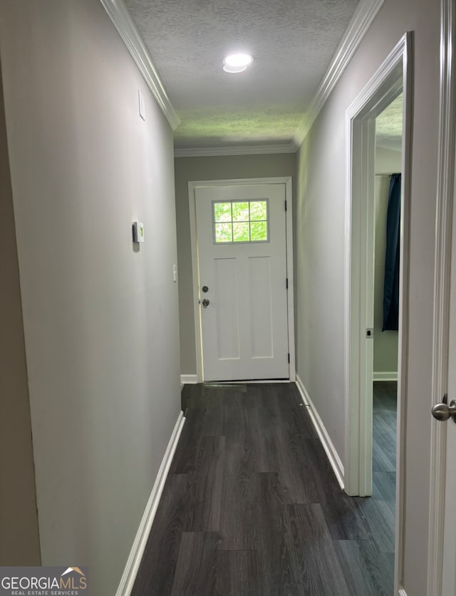 doorway featuring crown molding, a textured ceiling, and dark hardwood / wood-style flooring