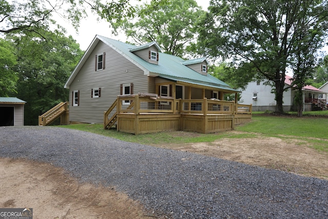 exterior space featuring a deck and a lawn