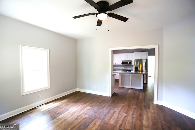 interior space with ceiling fan and dark hardwood / wood-style floors