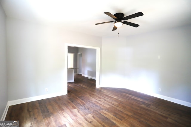 empty room featuring dark hardwood / wood-style flooring and ceiling fan