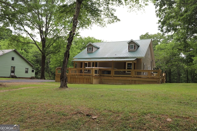 back of property featuring a lawn