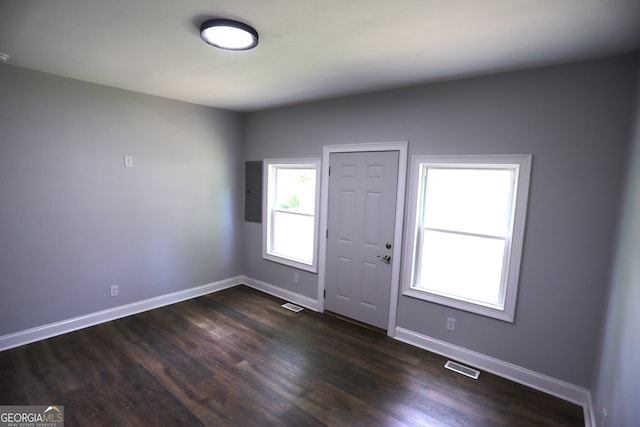 entryway with dark hardwood / wood-style flooring