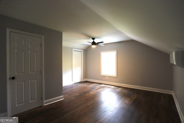 bonus room with ceiling fan, vaulted ceiling, and dark wood-type flooring