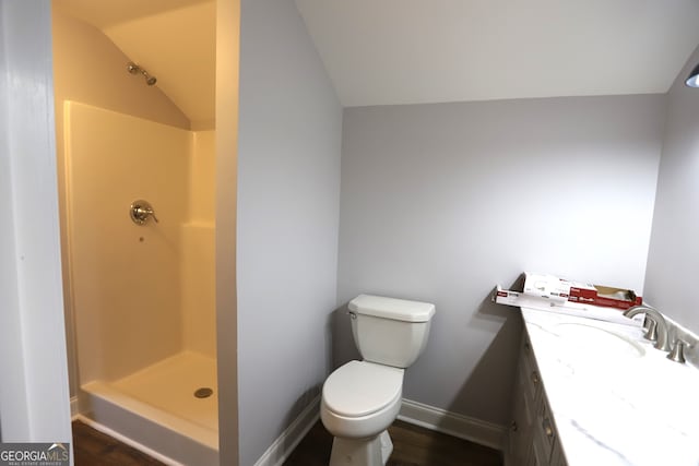 bathroom featuring vaulted ceiling, toilet, hardwood / wood-style floors, and walk in shower