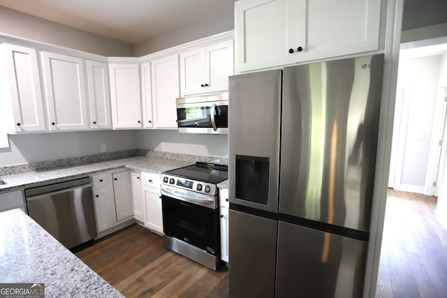 kitchen featuring white cabinetry, light stone countertops, dark hardwood / wood-style flooring, and appliances with stainless steel finishes