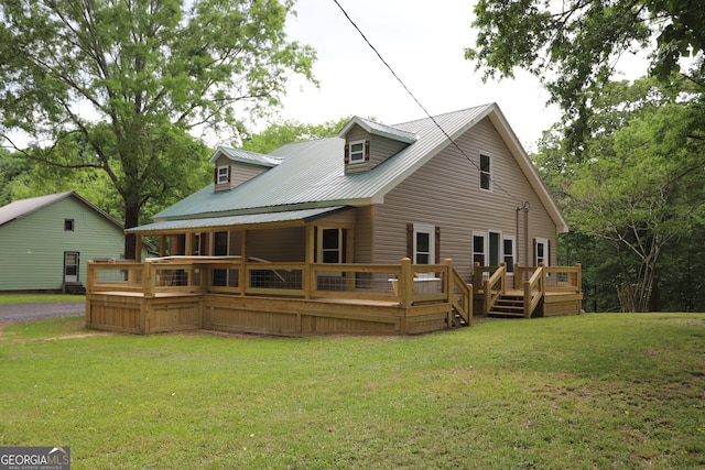 back of property with a wooden deck and a yard