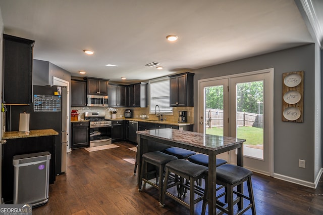 dining space with dark hardwood / wood-style flooring and sink