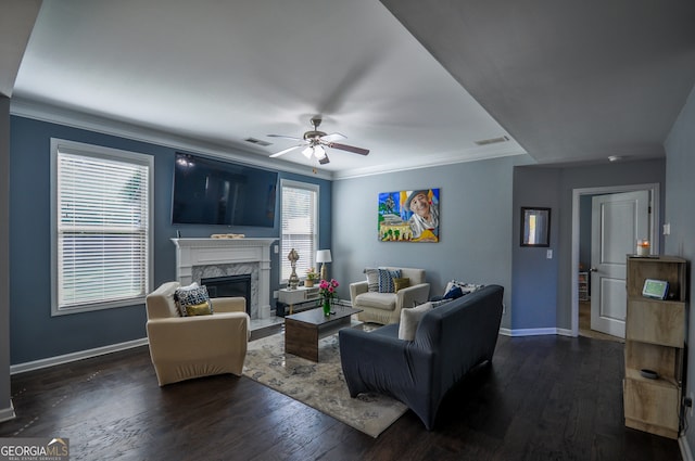 living room featuring ceiling fan, dark hardwood / wood-style floors, and a fireplace