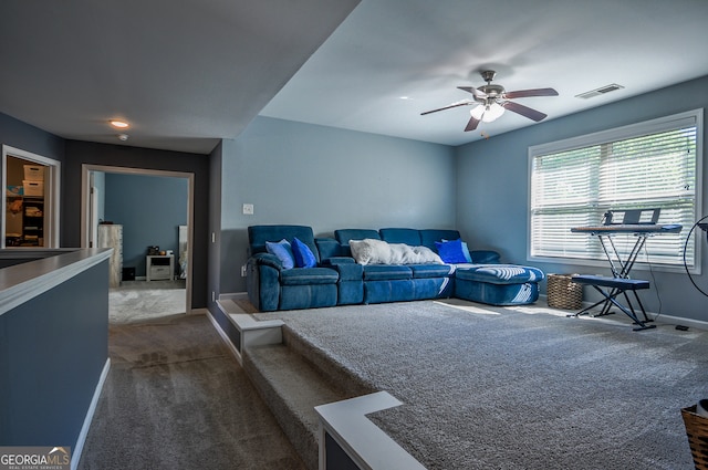 living room with dark colored carpet and ceiling fan