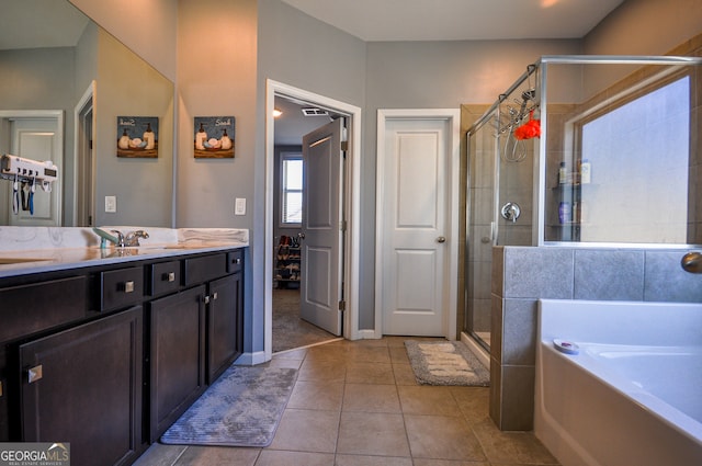 bathroom with tile flooring, independent shower and bath, and oversized vanity