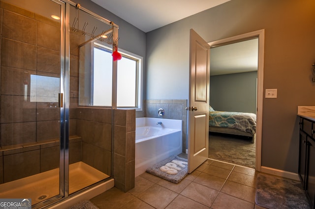 bathroom featuring shower with separate bathtub, vanity, and tile flooring