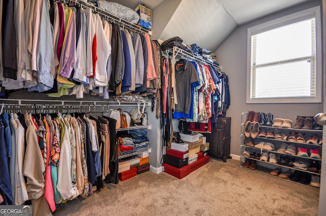 walk in closet with carpet flooring and lofted ceiling