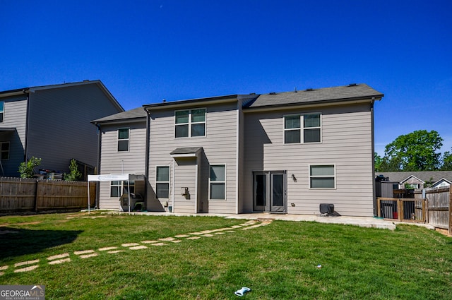 rear view of property with a lawn