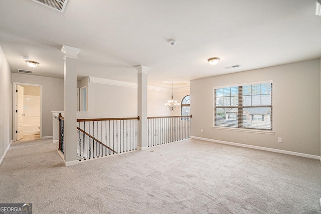 empty room with a notable chandelier and light colored carpet