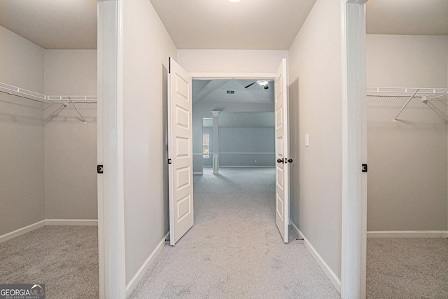 hall with light colored carpet