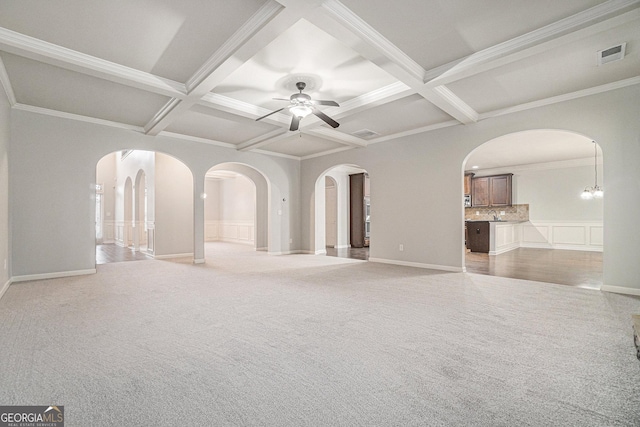 empty room featuring beamed ceiling, ornamental molding, ceiling fan, and coffered ceiling