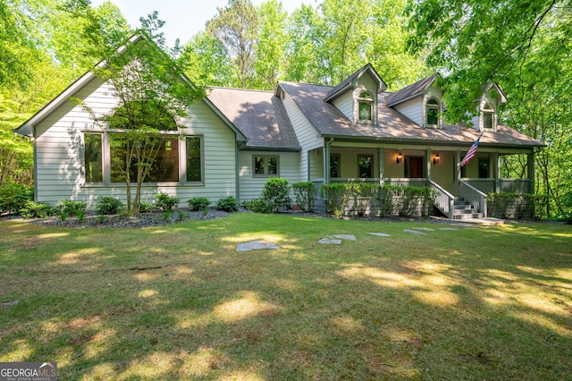 cape cod house featuring a front lawn and covered porch