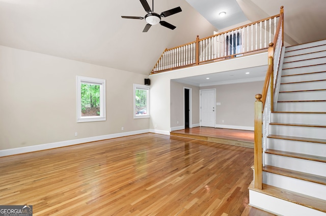 unfurnished living room featuring high vaulted ceiling, ceiling fan, and light wood-type flooring