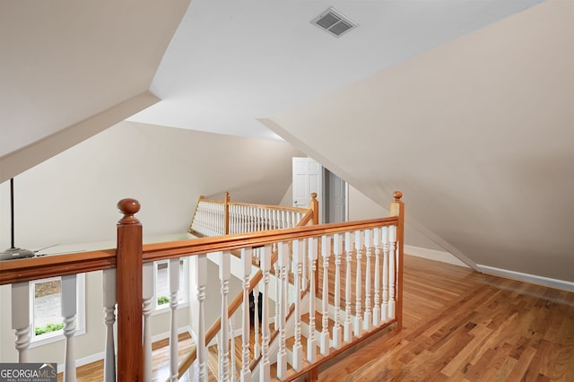 hallway with lofted ceiling and wood-type flooring