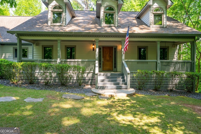 cape cod-style house with covered porch and a front yard