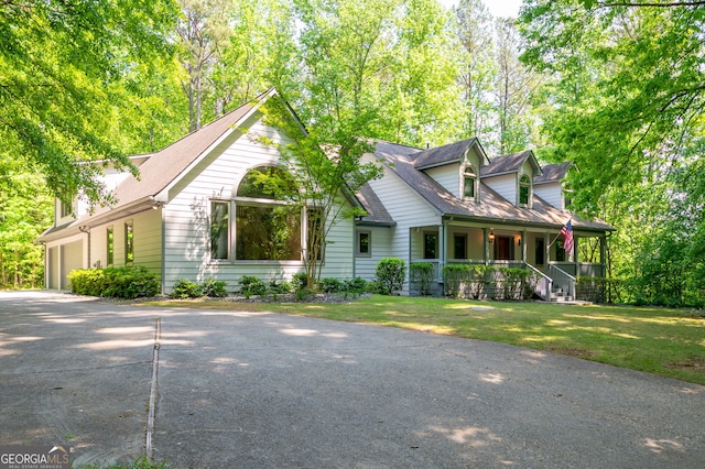 cape cod home featuring a front lawn and covered porch