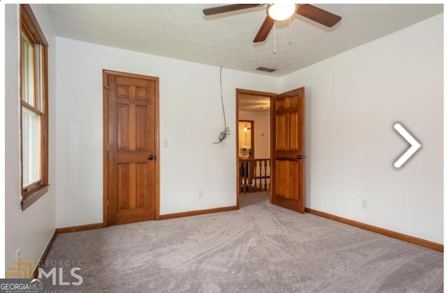 unfurnished bedroom featuring ceiling fan and carpet flooring