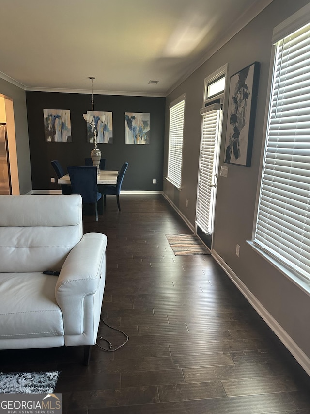 living room featuring dark hardwood / wood-style floors and crown molding