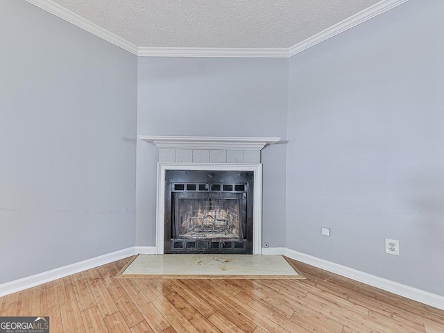 interior details with ornamental molding, hardwood / wood-style flooring, and a textured ceiling