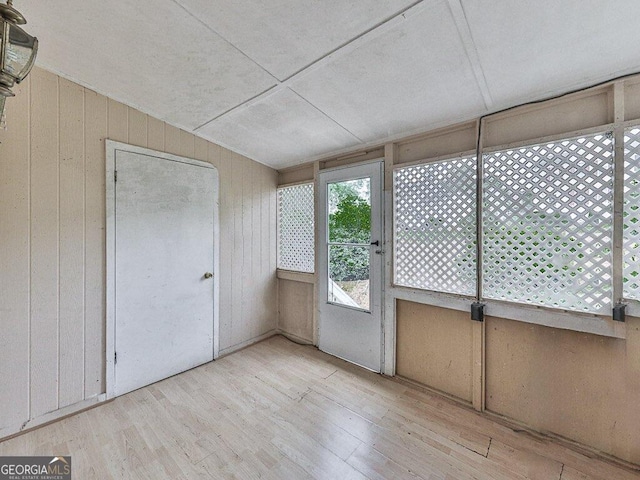 unfurnished sunroom with vaulted ceiling