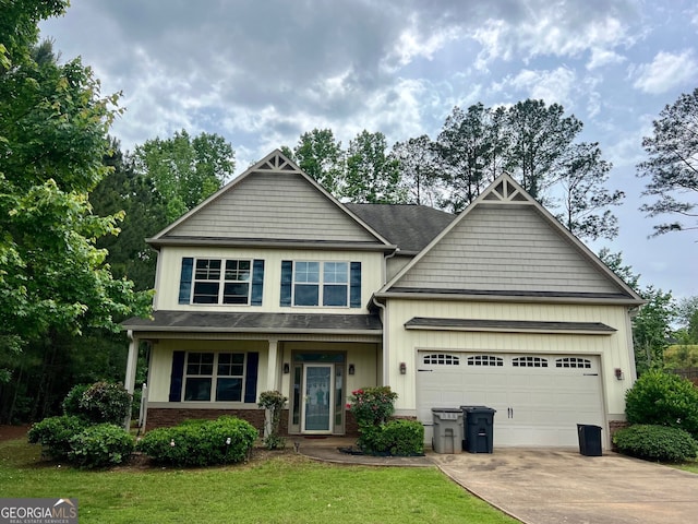 craftsman-style house featuring a front lawn and a garage