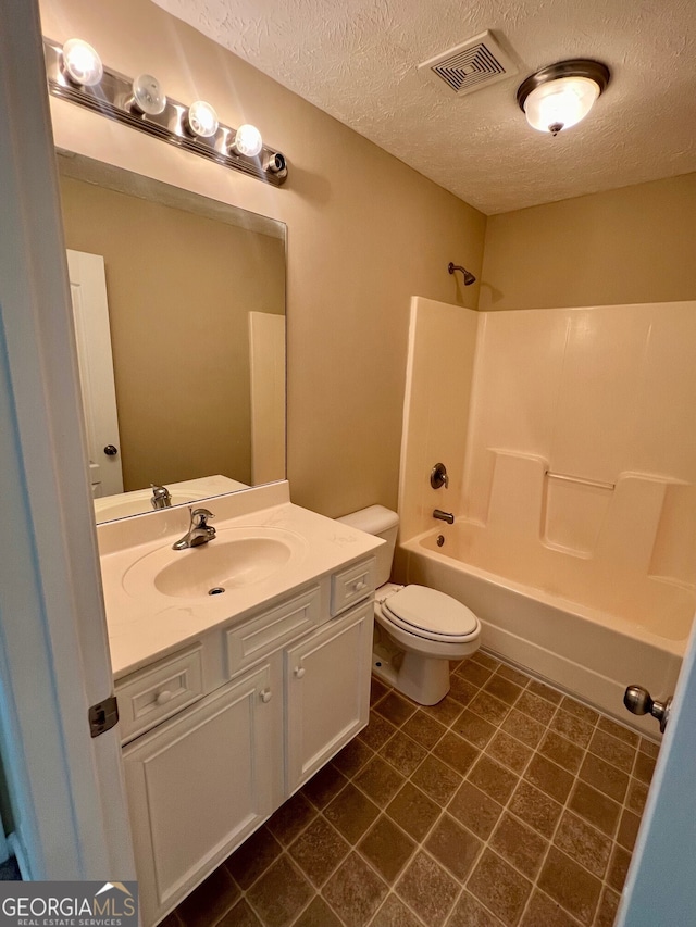 full bathroom with toilet, tile flooring, a textured ceiling, vanity, and bathing tub / shower combination