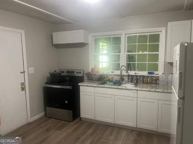 kitchen featuring white cabinetry, white refrigerator, dark hardwood / wood-style floors, and stainless steel electric range