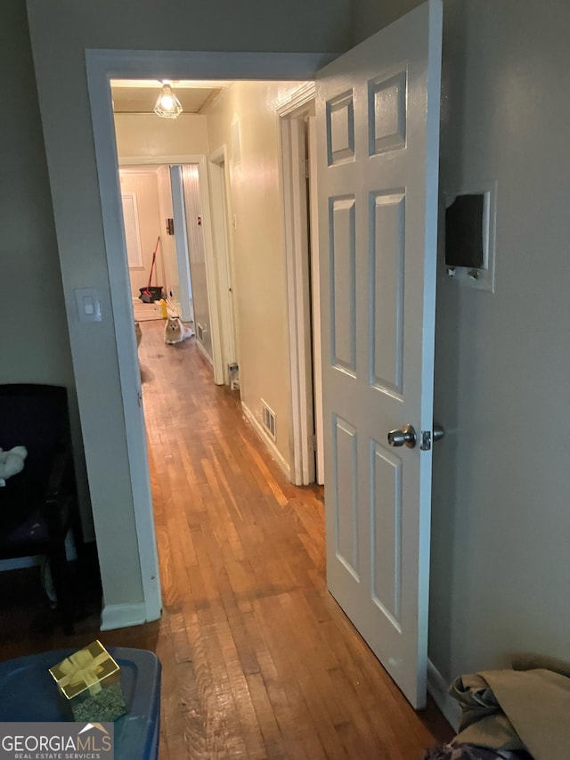 hallway featuring wood-type flooring