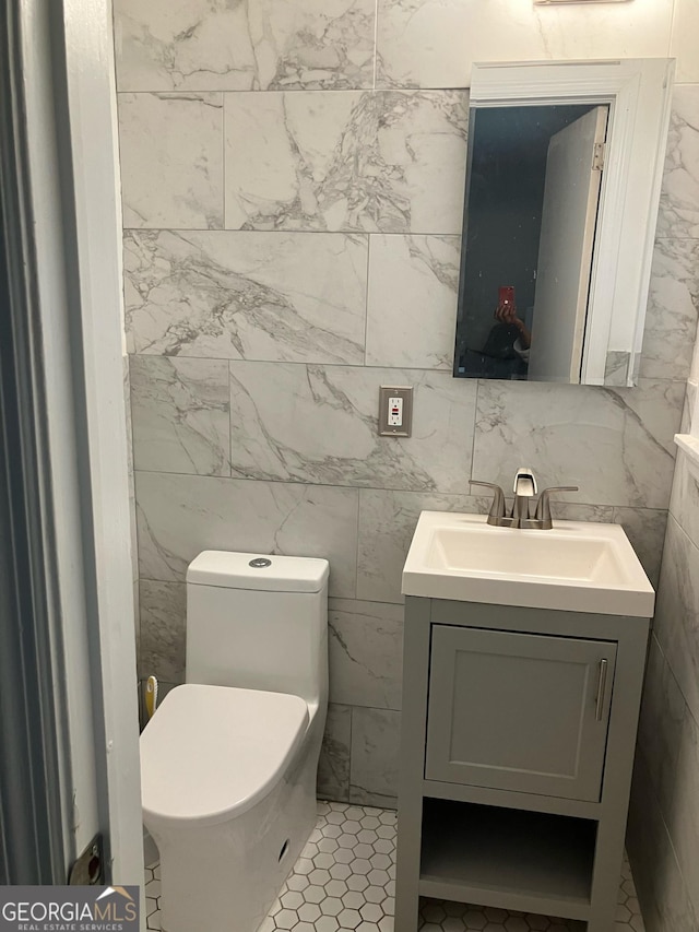 bathroom with tile patterned floors, vanity, and toilet