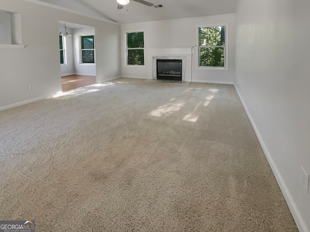 unfurnished living room with carpet and ceiling fan