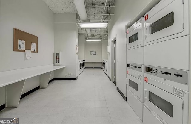 interior space featuring independent washer and dryer, stacked washer and dryer, and light tile floors