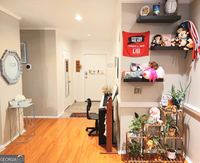 interior space featuring hardwood / wood-style floors and ornamental molding