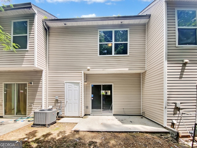 back of property featuring central AC unit and a patio area