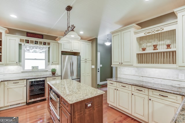 kitchen with light stone countertops, decorative light fixtures, appliances with stainless steel finishes, tasteful backsplash, and wine cooler