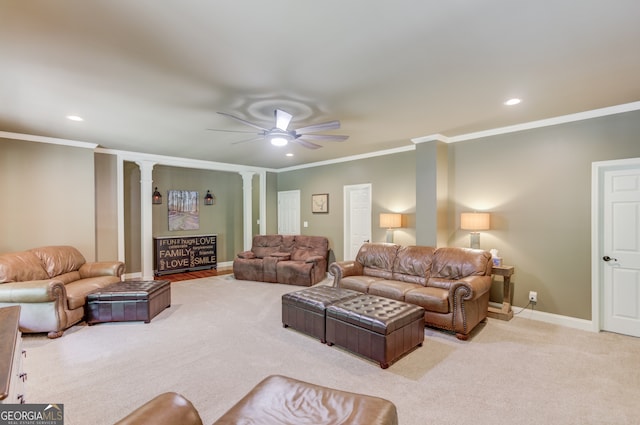 carpeted living room with crown molding, ceiling fan, and decorative columns