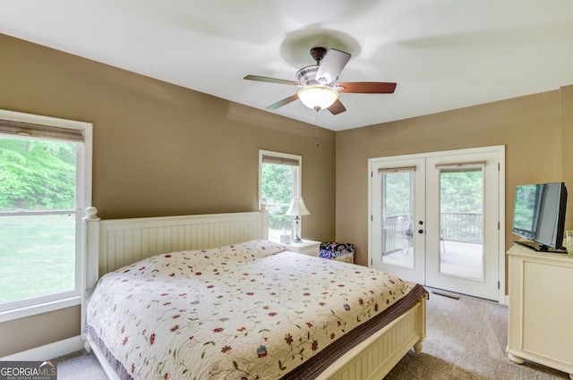 carpeted bedroom with french doors, ceiling fan, and access to exterior