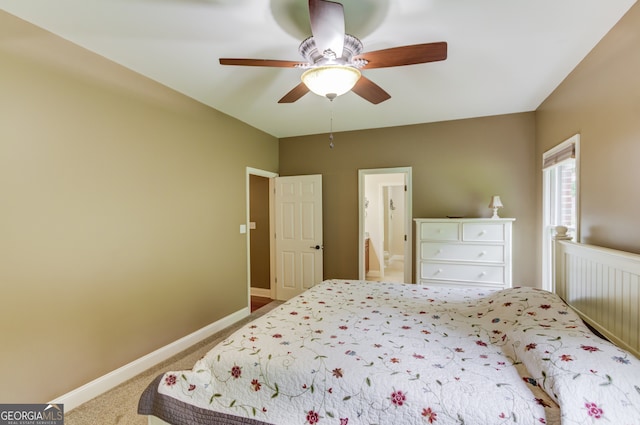 carpeted bedroom featuring ceiling fan and ensuite bathroom