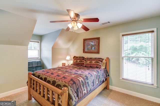 carpeted bedroom with ceiling fan and lofted ceiling