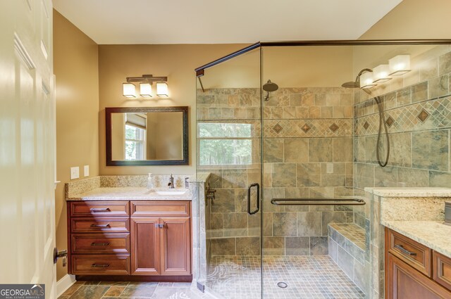 bathroom featuring tile flooring, large vanity, and a shower with shower door