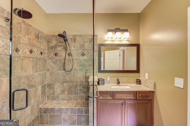 bathroom featuring an enclosed shower and large vanity